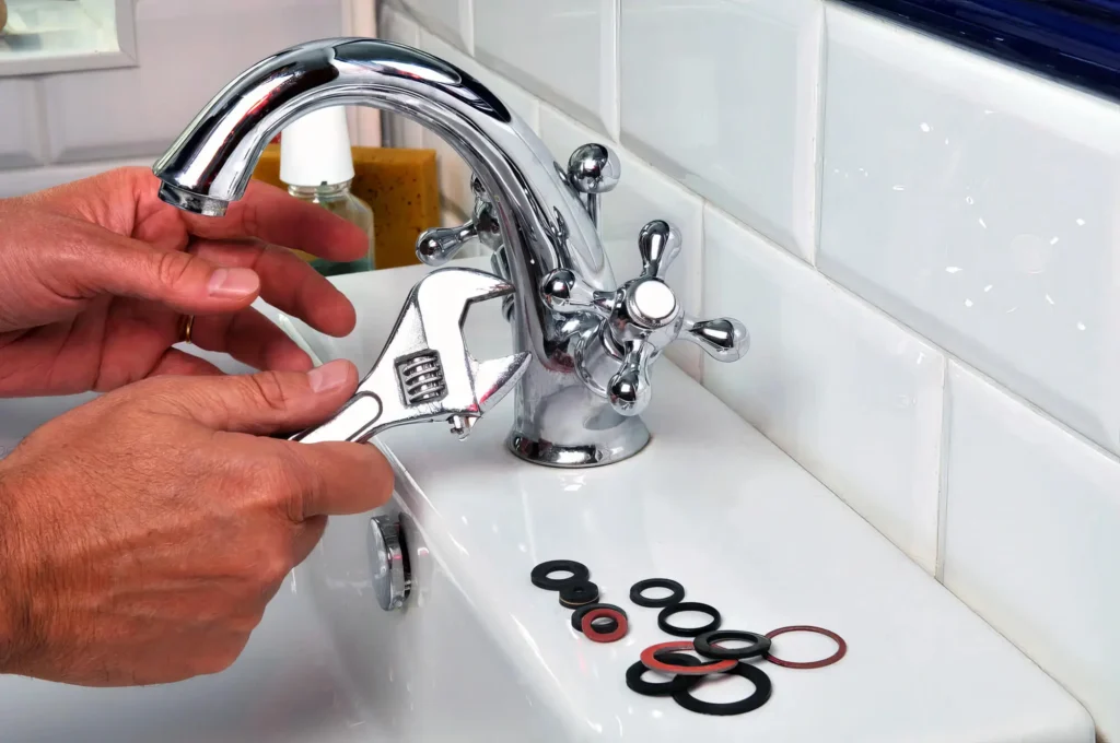 Plumber performing maintenance on a bathroom faucet in Thornton