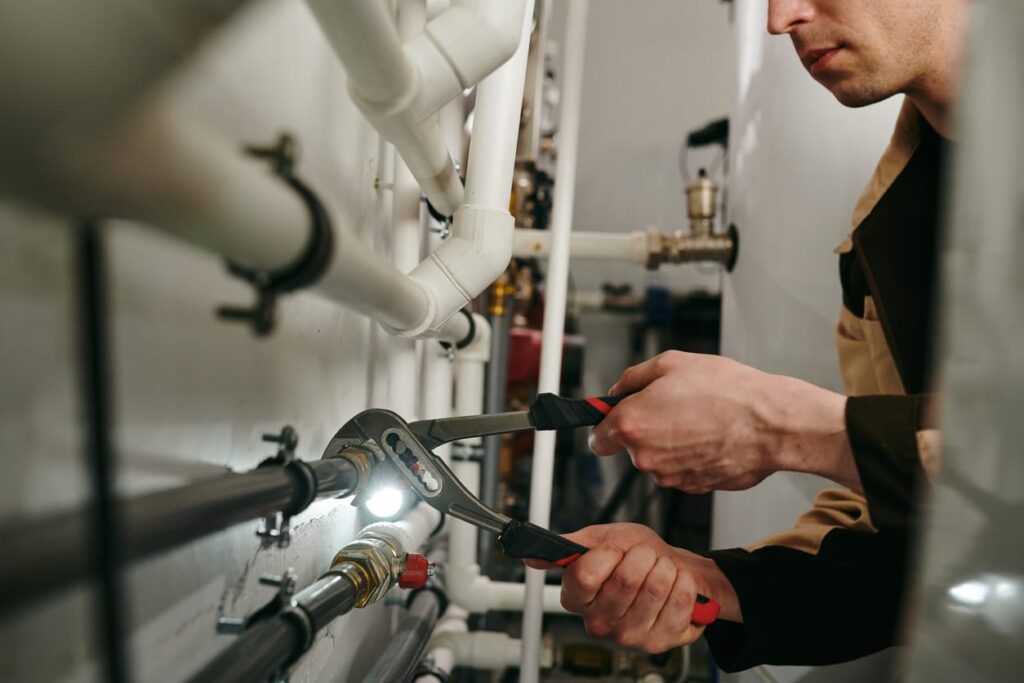 Plumbers maintaining commercial plumbing pipes in Thornton