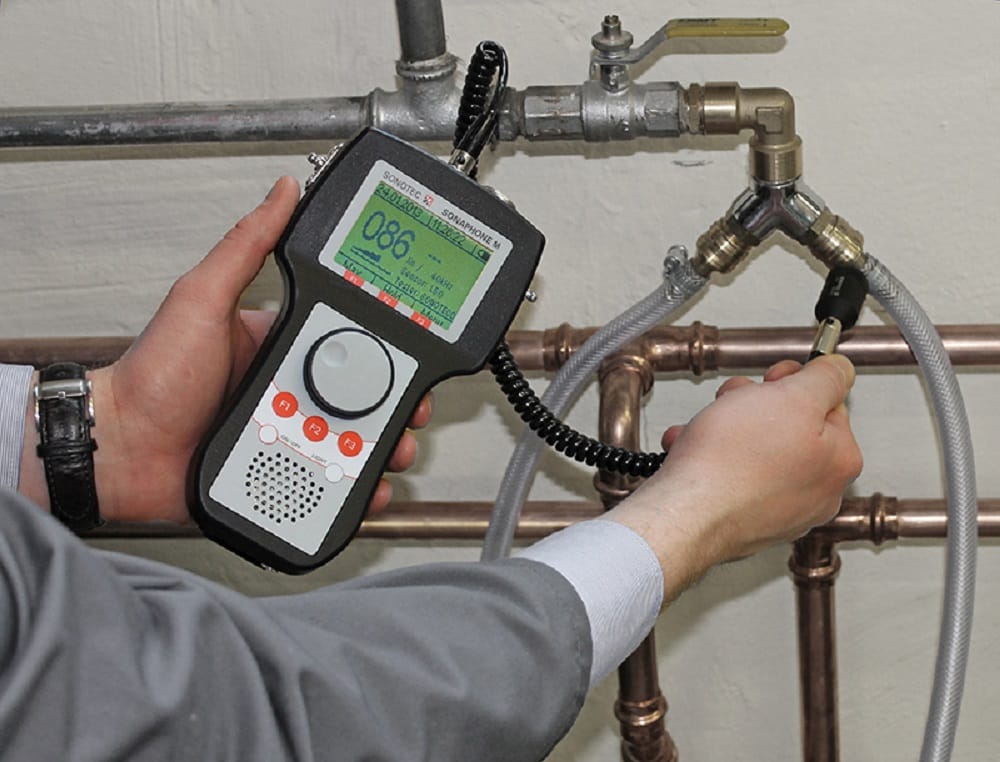 Plumber testing pipes with electronic leak detection equipment in Thornton
