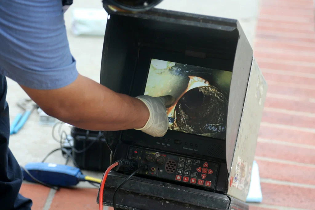 Technician viewing a drain inspection camera in Thornton