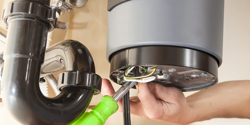 Technician repairing the heating element of a water heater in Thornton